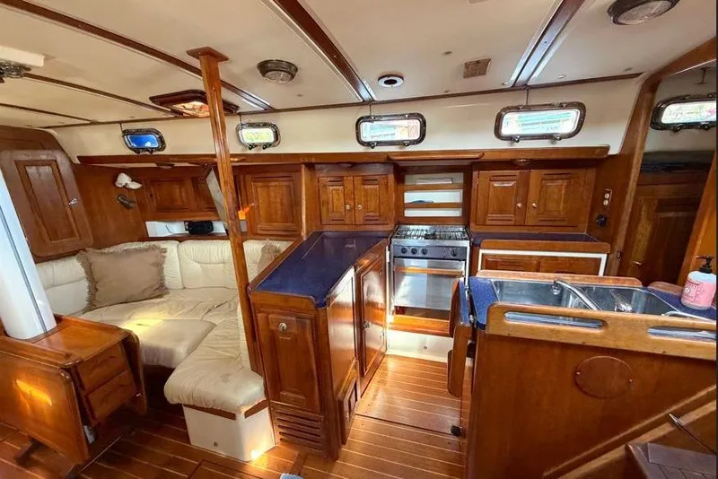Slide: The Image of Luxurious 2001 Tartan 3700 yacht interior with wood finish and modern kitchen amenities. - 23