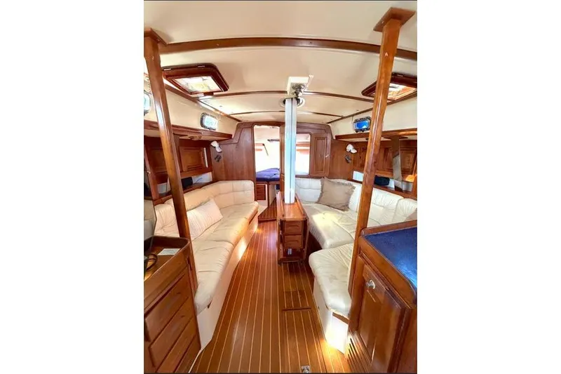 Slide: The Image of Luxurious interior of 2001 Tartan 3700 sailboat with wood finish and plush seating. - 24