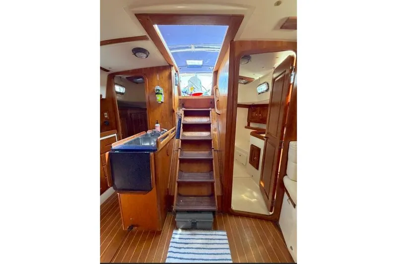 Slide: The Image of Interior of 2001 Tartan 3700 sailboat with wooden stairs and cabinetry. - 25