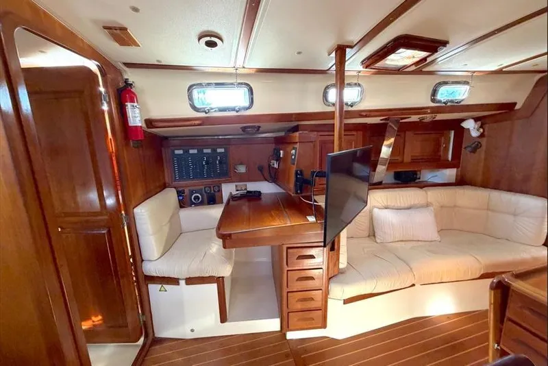 Slide: The Image of Interior of 2001 Tartan 3700 sailboat with wood finish and cozy seating area. - 27
