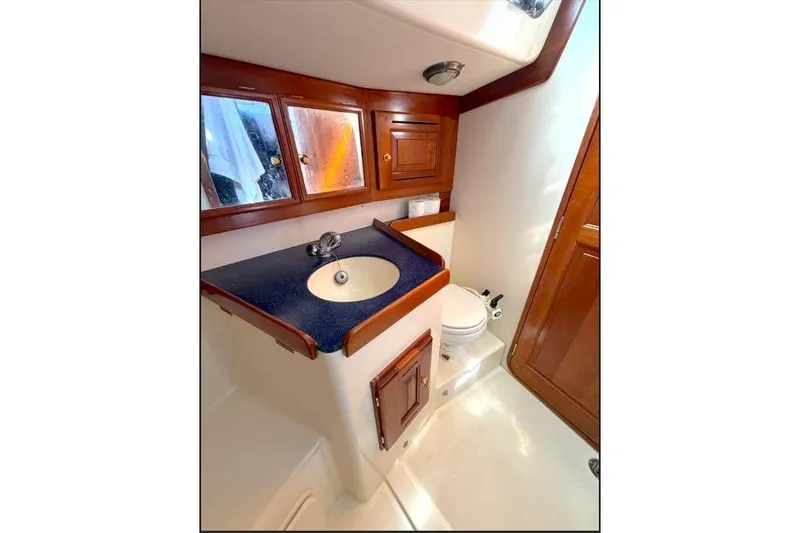 Slide: The Image of Luxurious Tartan 3700 2001 yacht bathroom with wooden cabinets and modern fixtures. - 28