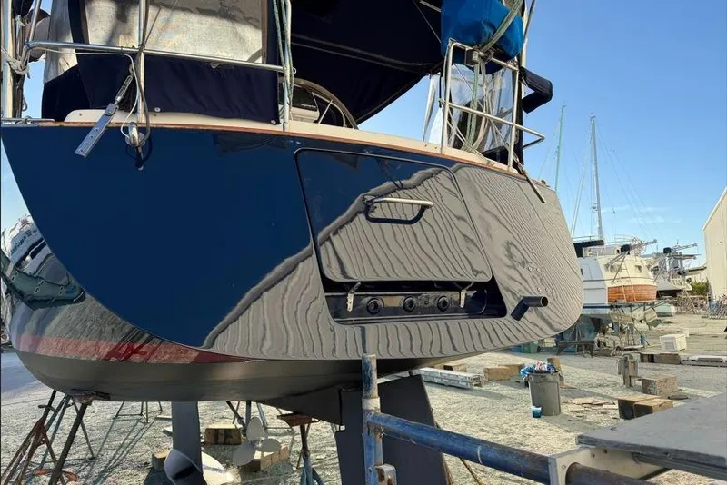 Slide: The Image of Tartan 3700 sailboat from 2001 on dry dock, showcasing its sleek hull design. - 3