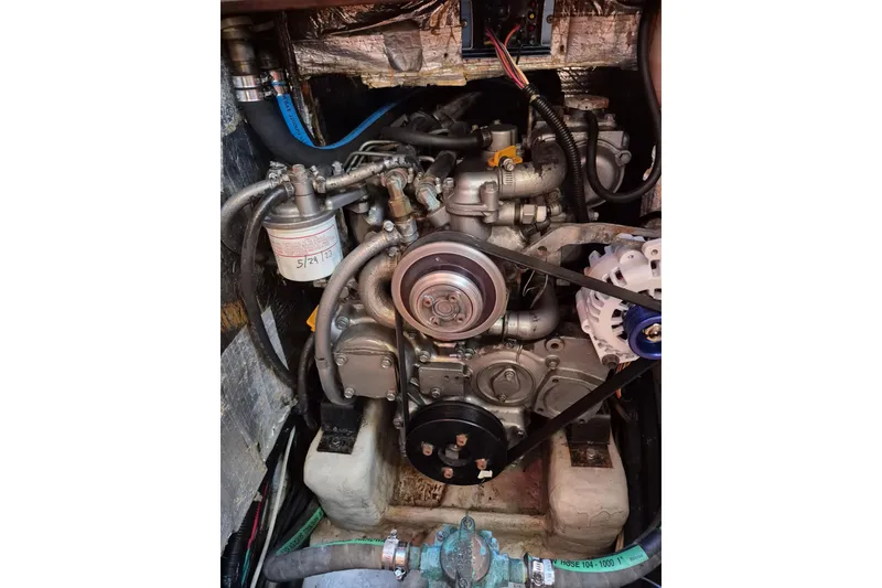 Slide: The Image of Engine compartment of a 2001 Tartan 3700 sailboat, showcasing mechanical components and hoses. - 31