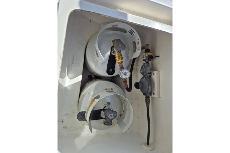Slide: The Image of Propane tank compartment in 2001 Tartan 3700 boat, featuring dual tanks and regulator. - 33
