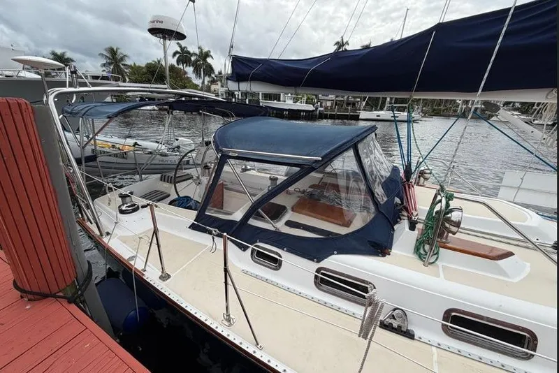 Slide: The Image of Sailboat docked at marina, Tartan 3700 model, 2001, with blue canopy and rigging. - 5