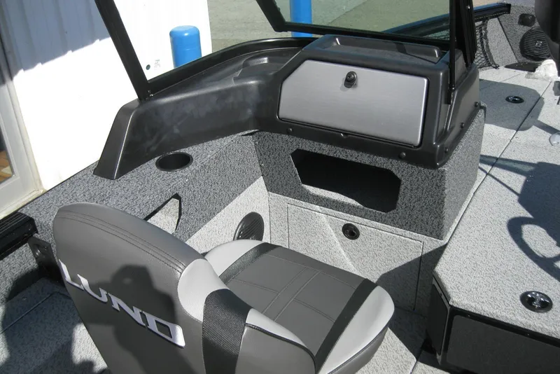Slide: The Image of 2026 Lund 1775 Impact XS Sport boat interior with gray seating and storage compartments. - 10