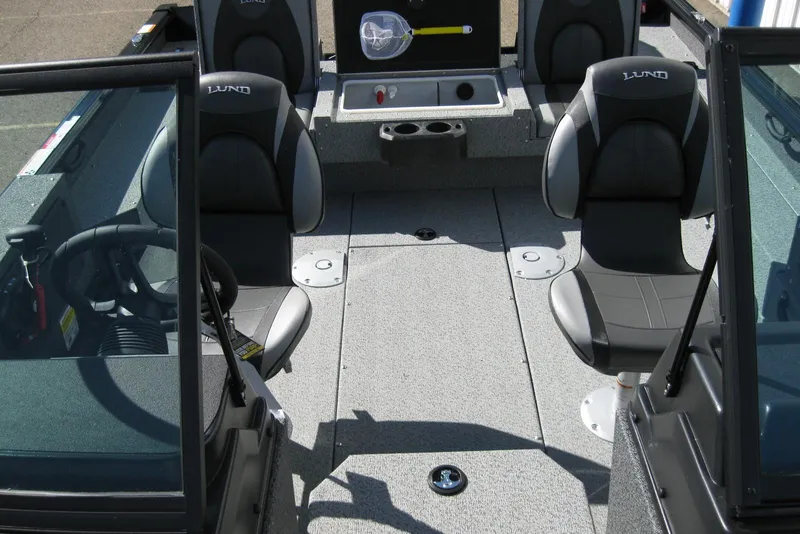 Slide: The Image of 2026 Lund 1775 Impact XS Sport boat interior with seating and steering wheel. - 14