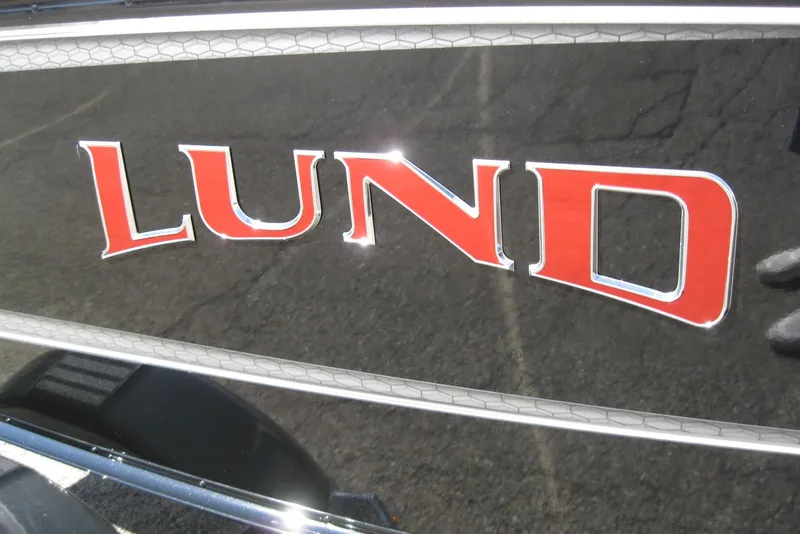 Slide: The Image of 2026 Lund 1775 Impact XS Sport boat logo in bold red lettering. - 3