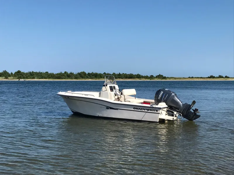 Slide: The Image of 2010 Grady-White Sportsman 180 boat on calm water near shoreline. - 4