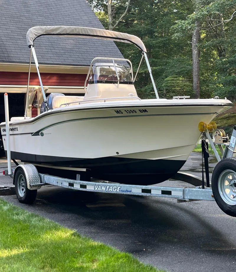 Slide: The Image of 2010 Grady-White Sportsman 180 boat on trailer, parked in driveway near garage. - 6