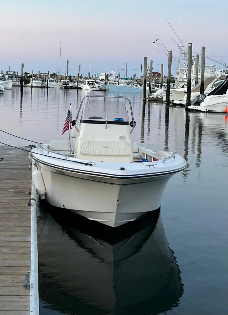 Slide: The Image of 2010 Grady-White Sportsman 180 boat docked in a marina at sunset. - 7