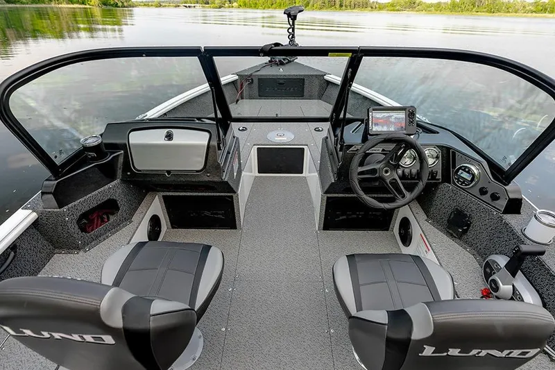 Slide: The Image of Manufacturer Provided Image: 2026 Lund 1700 Explorer Sport boat interior with steering wheel and seating on a calm lake. - 1