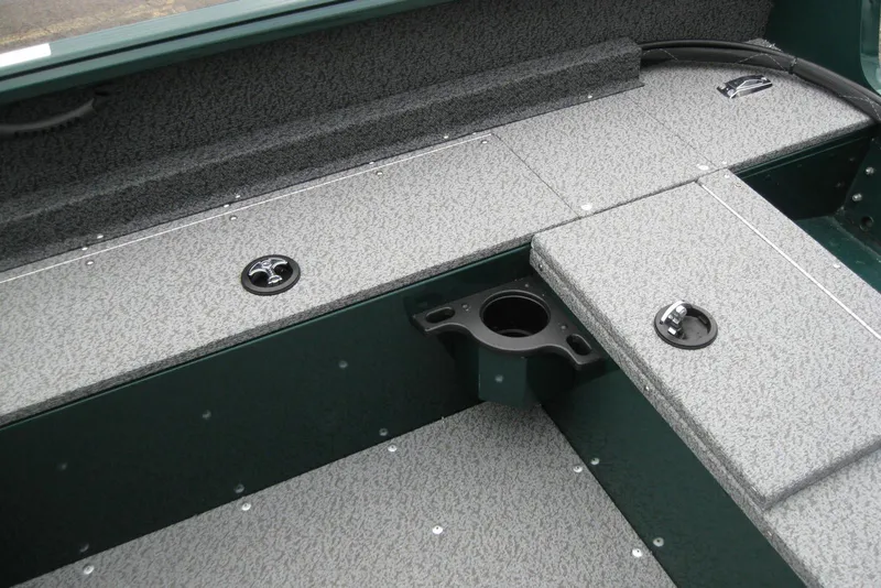 Slide: The Image of 2026 Lund 1700 Explorer Sport boat interior with gray textured flooring and storage compartments. - 11