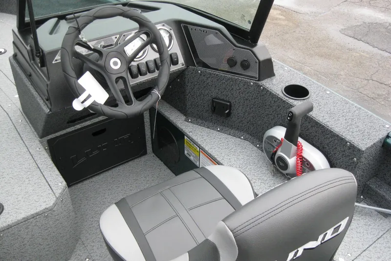 Slide: The Image of Interior of 2026 Lund 1700 Explorer Sport boat, featuring steering wheel and control panel. - 15