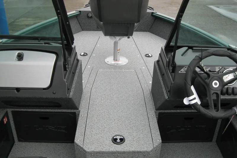 Slide: The Image of 2026 Lund 1700 Explorer Sport boat interior with steering wheel and seating. - 17