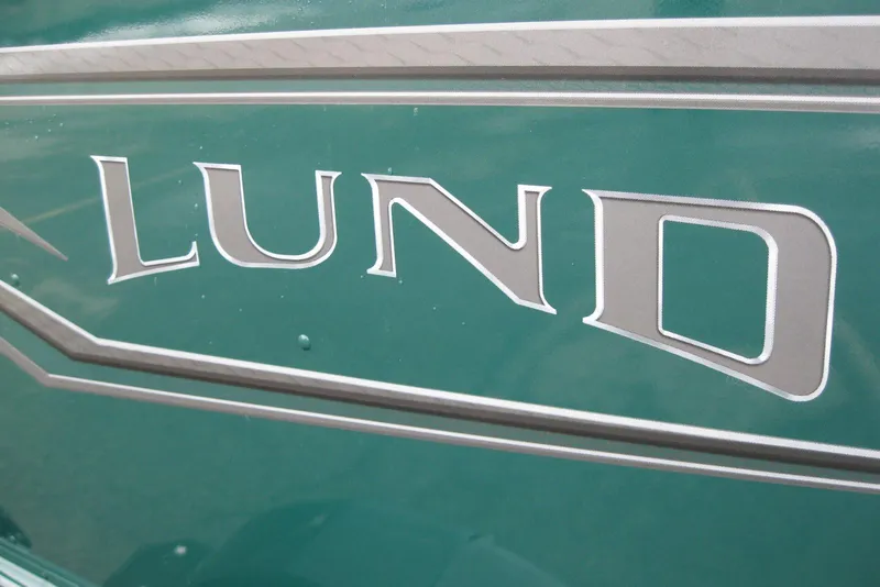 Slide: The Image of Close-up of 2026 Lund 1700 Explorer Sport logo on green surface. - 4