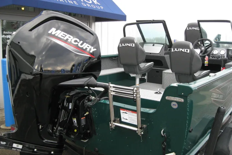 Slide: The Image of 2026 Lund 1700 Explorer Sport boat with Mercury outboard motor, docked at marine group. - 6
