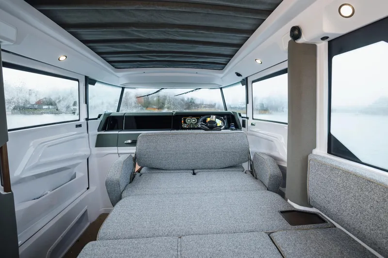 Slide: The Image of Interior of 2026 Axopar 38 Cross Cabin, featuring modern navigation controls and panoramic windows. - 12