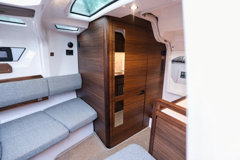 Slide: The Image of Interior of 2026 Axopar 38 Cross Cabin with modern seating and table. - 15