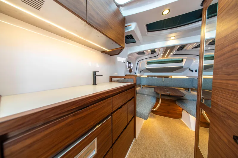 Slide: The Image of Luxurious interior of 2026 Axopar 38 Cross Cabin with modern wood finishes and seating area. - 27