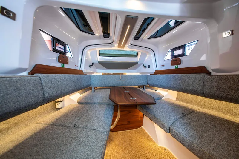 Slide: The Image of Interior of 2026 Axopar 38 Cross Cabin with modern seating and wooden table. - 28