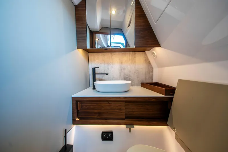 Slide: The Image of Luxurious bathroom interior of 2026 Axopar 38 Cross Cabin with modern sink and wood accents. - 30