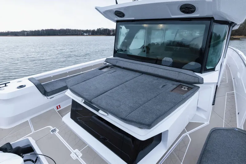 Slide: The Image of 2026 Axopar 38 Cross Cabin boat on water at sunset with illuminated engines. - 7