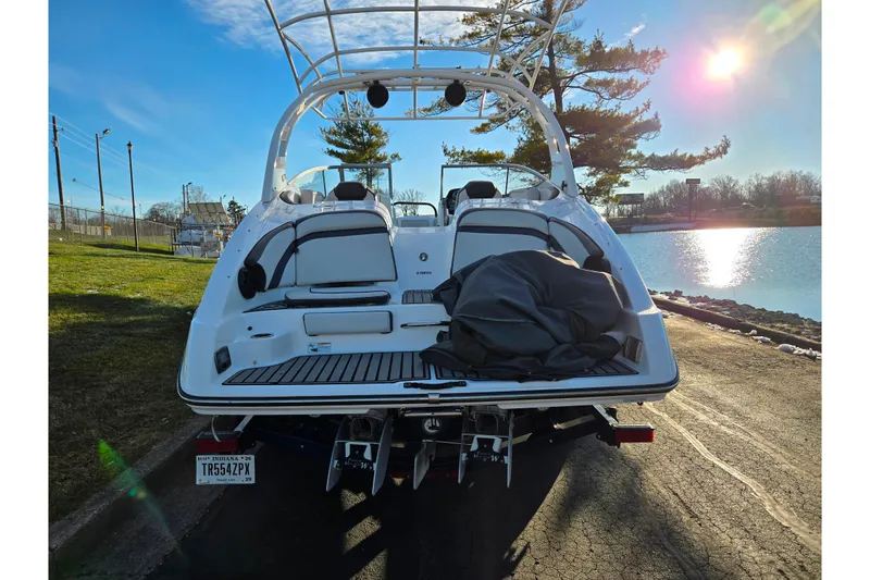 Slide: The Image of 2017 Yamaha Boats 242 Limited S E-Series on trailer by a lake at sunset. - 2