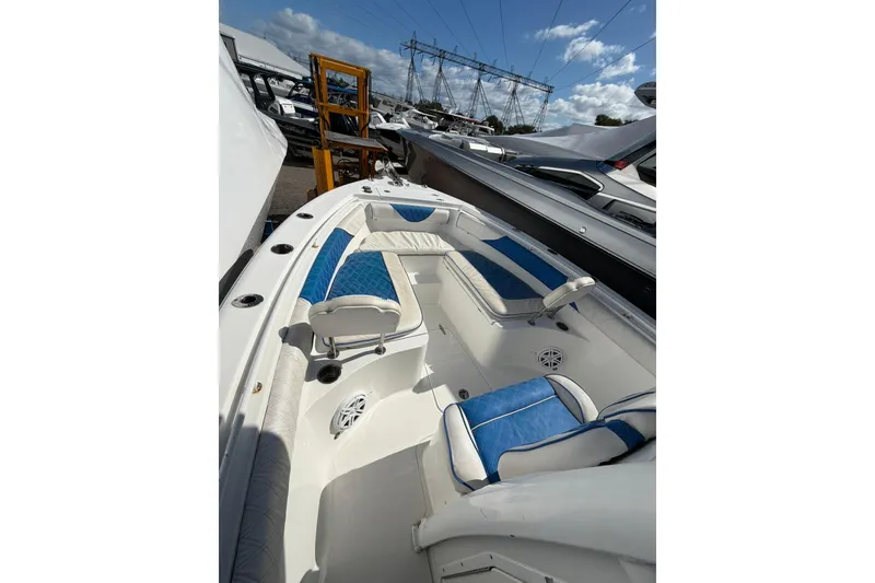 Slide: The Image of 2015 Sea Hunt Gamefish 25 boat interior with blue and white seating. - 8