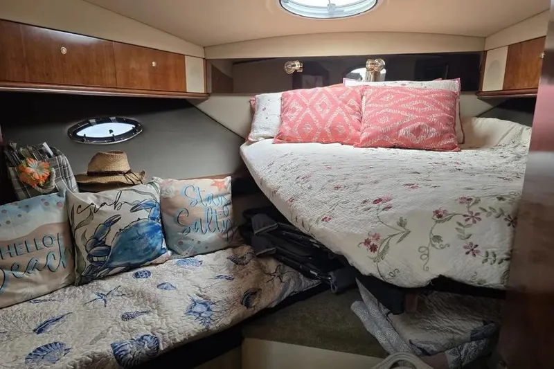 Slide: The Image of 2005 Cruisers Yachts 440 Express cabin with cozy bedding and decorative pillows. - 14