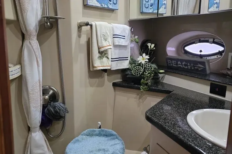 Slide: The Image of Luxurious 2005 Cruisers Yachts 440 Express bathroom with elegant decor and modern amenities. - 15