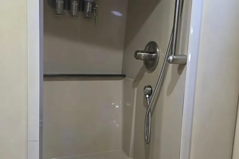 Slide: The Image of Shower area in 2005 Cruisers Yachts 440 Express, featuring modern fixtures and dispensers. - 19