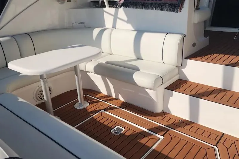 Slide: The Image of 2005 Cruisers Yachts 440 Express interior with white seating and wooden flooring. - 4