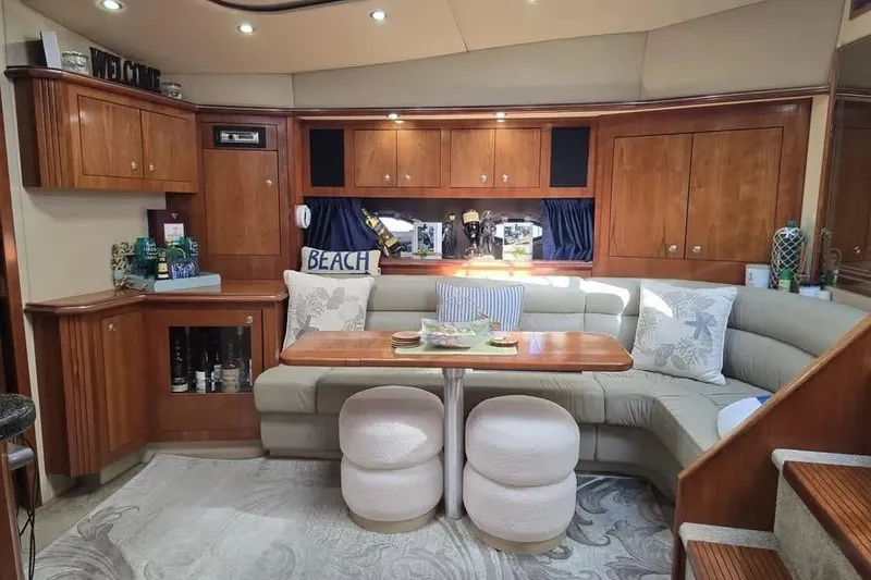 Slide: The Image of Luxurious 2005 Cruisers Yachts 440 Express interior with elegant wood cabinetry and cozy seating. - 9