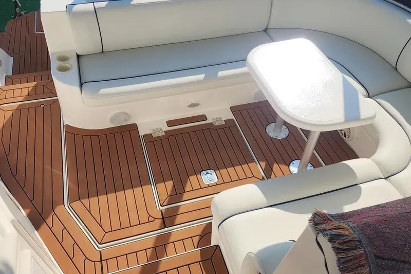 Slide: The Image of 2005 Cruisers Yachts 440 Express interior with white seating and wooden flooring. - 5