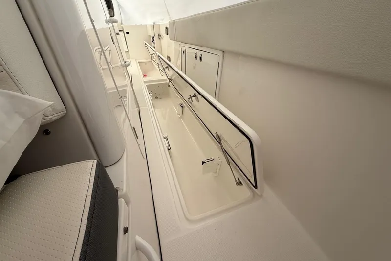 Slide: The Image of Interior view of 2023 Edgewater 340CC boat, showcasing storage compartments. - 15