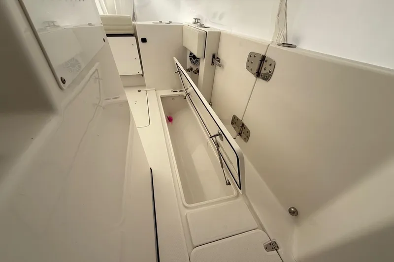 Slide: The Image of 2023 Edgewater 340CC boat interior with storage compartment and sleek design. - 16