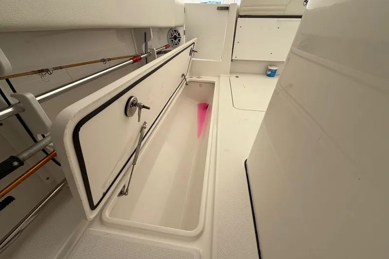 Slide: The Image of 2023 Edgewater 340CC boat interior with open storage compartment. - 17