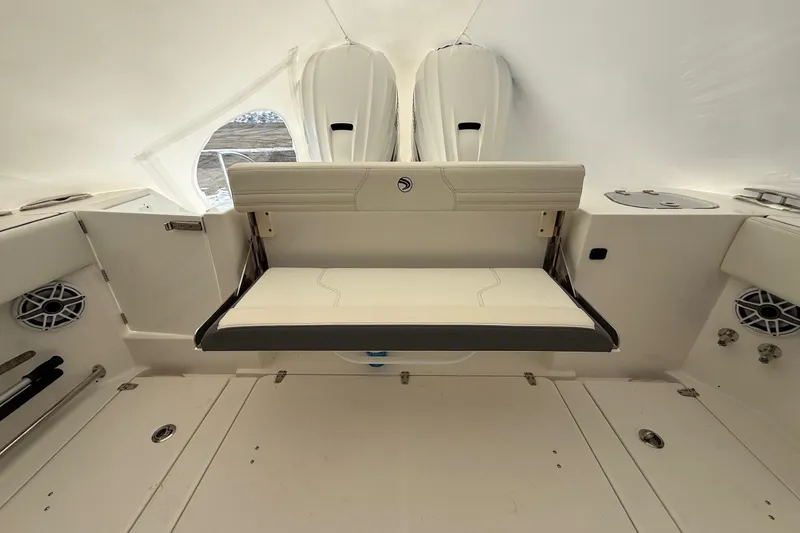 Slide: The Image of 2023 Edgewater 340CC boat interior with foldable seating and modern design. - 18