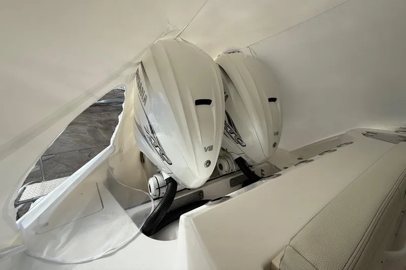 Slide: The Image of 2023 Edgewater 340CC boat with dual Yamaha V8 engines, covered in protective wrap. - 30
