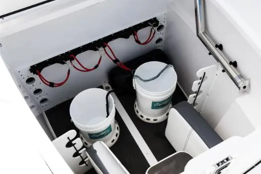 Slide: The Image of 2023 Edgewater 340CC boat interior with open storage compartments and drawers. - 6