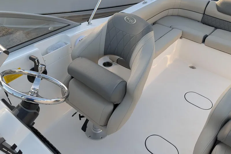 Slide: The Image of 2026 Key West 203 DFS boat interior with steering wheel and cushioned seating. - 12