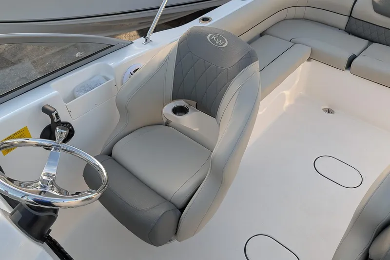 Slide: The Image of 2026 Key West 203 DFS boat interior with steering wheel and cushioned seating. - 13