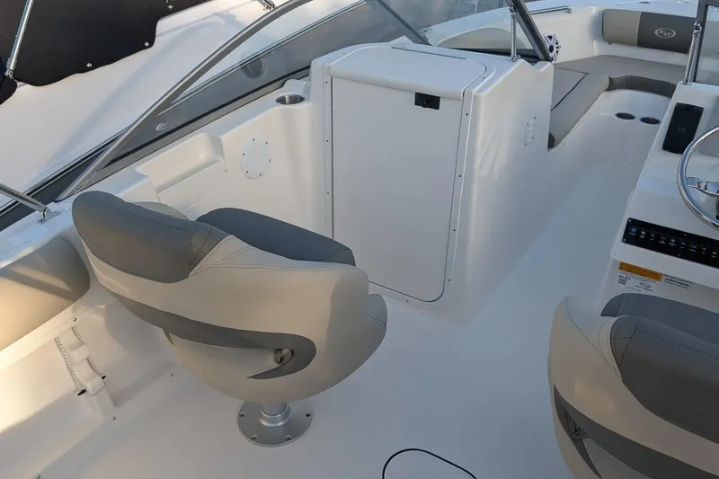 Slide: The Image of 2026 Key West 203 DFS boat interior with seating and steering console. - 15