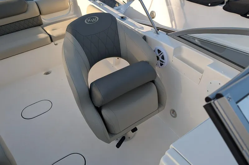 Slide: The Image of 2026 Key West 203 DFS boat interior with cushioned seating and speaker. - 16