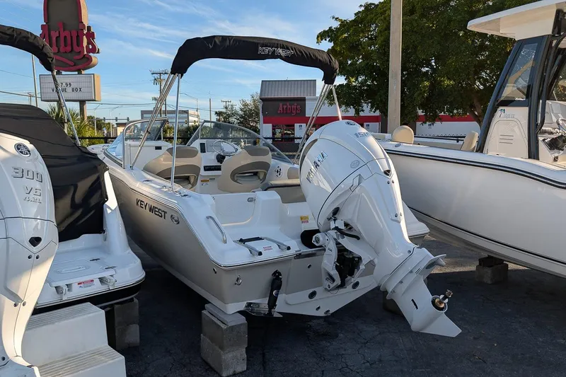 Slide: The Image of 2026 Key West 203 DFS boat with Yamaha engine displayed outdoors near Arby's. - 2