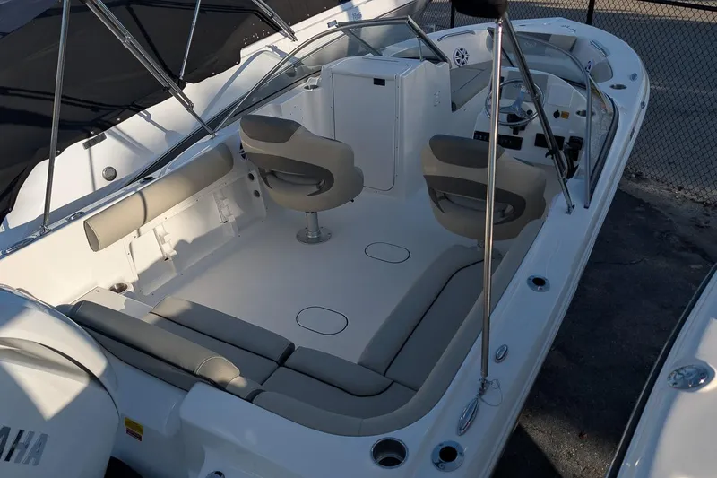 Slide: The Image of 2026 Key West 203 DFS boat interior with seating and steering console. - 4