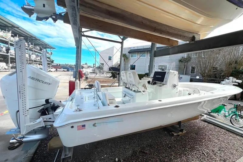 The Image of 2025 Contender 26 Bay boat with Mercury engine, docked in a marina setting. - 0