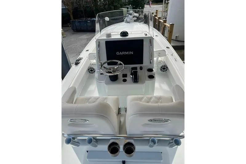 Slide: The Image of 2025 Contender 26 Bay boat interior with Garmin navigation system and dual seating. - 1