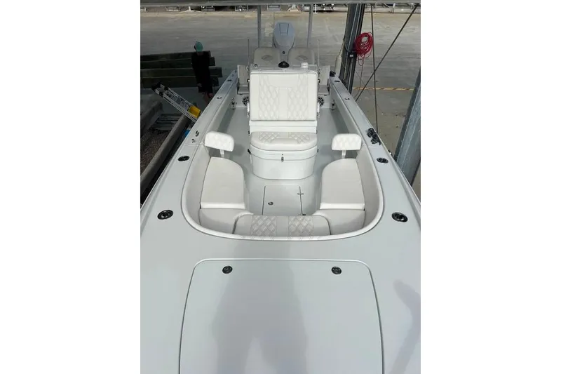 Slide: The Image of 2025 Contender 26 Bay boat interior with white seating and modern design. - 11